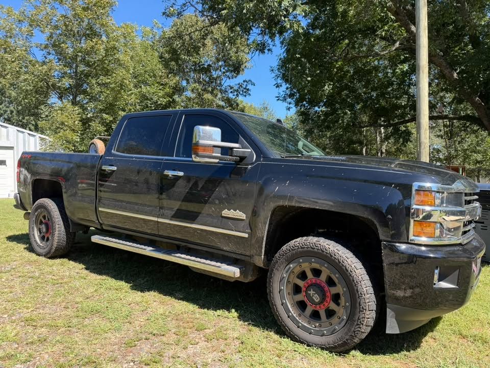 A black dually pickup with tinted windows