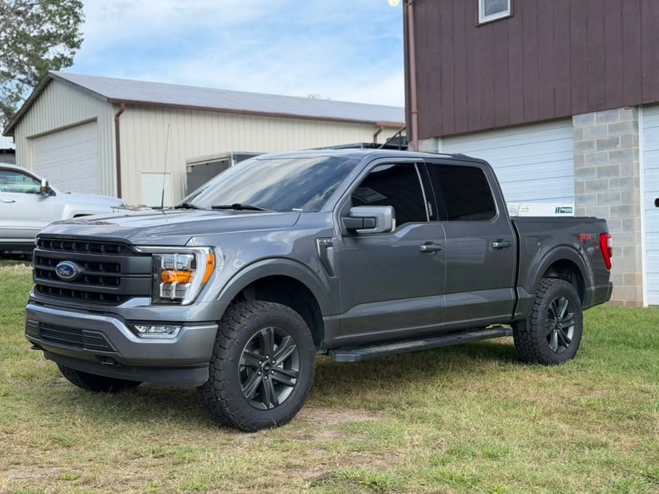 A grey Ford F-150 with tinted windows