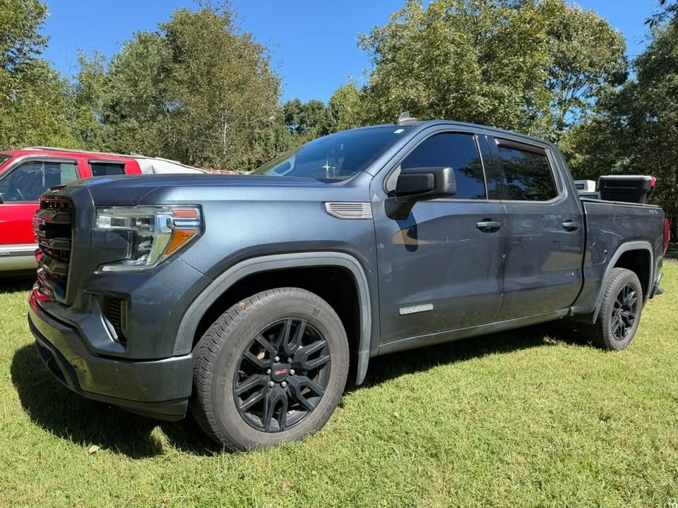 A grey GMC Sierra with tinted windows