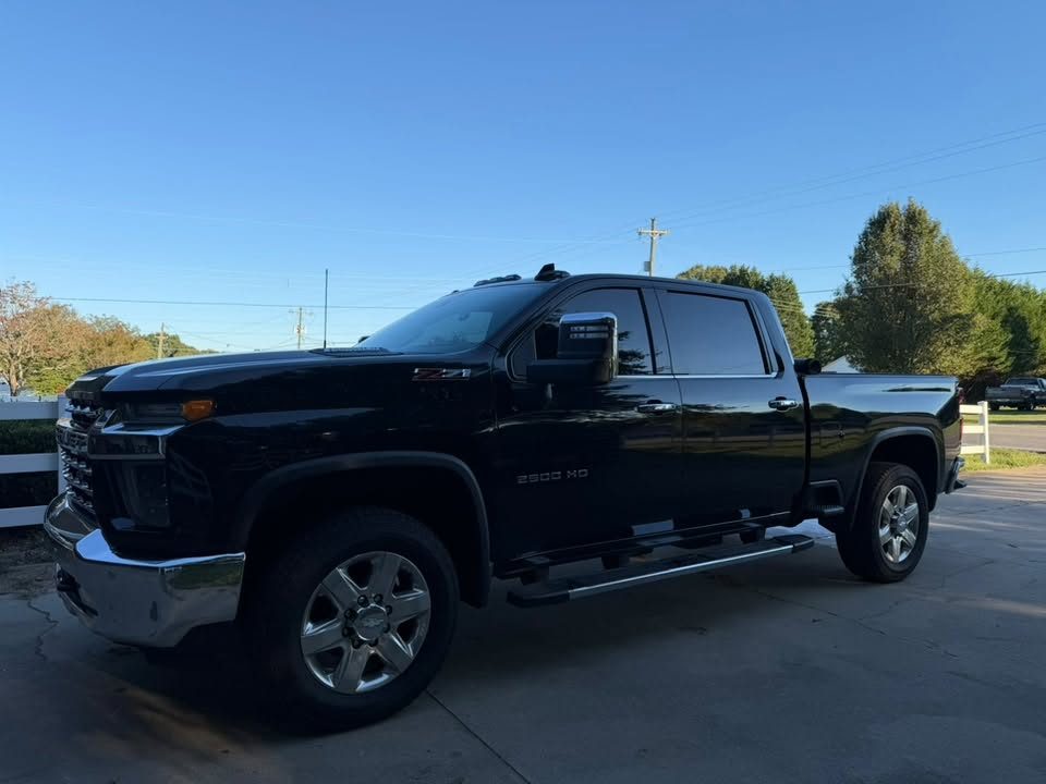 A black Chevrolet Silverado HD with tinted windows